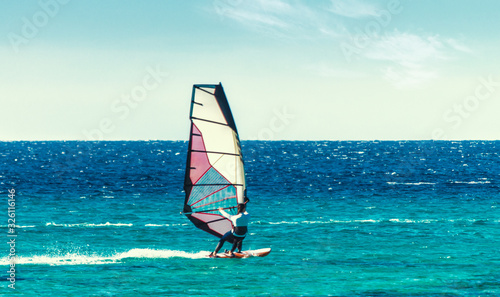 young surfer girl rides a sail in the Red Sea in Egypt Sharm el Sheikh