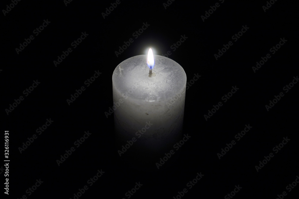 Candle flame close-up on a black background. Candle flame close-up on a black background.