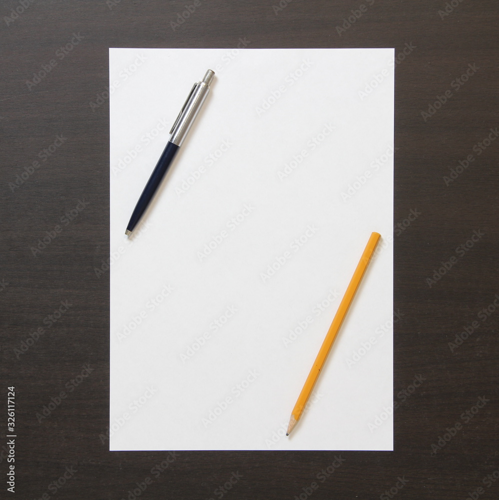 Template of white paper with pen and pencil on dark wenge color wooden background. Template of white paper with pen and pencil on dark wenge color wooden background.