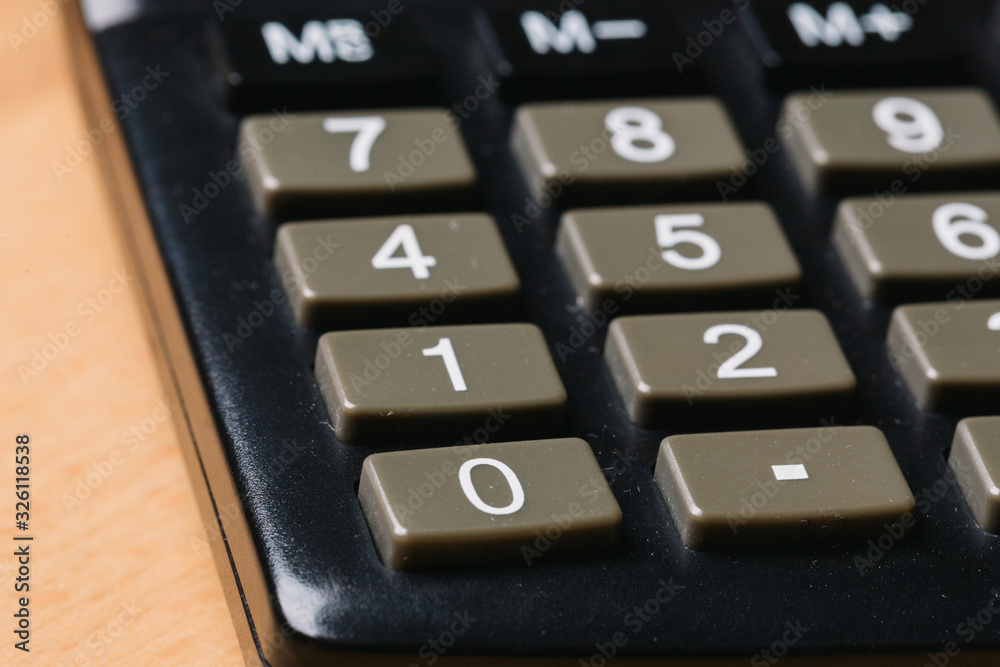 Modern calculator, Business and Finance accounting concept on wooden table Modern calculator, Business and Finance accounting concept on wooden table