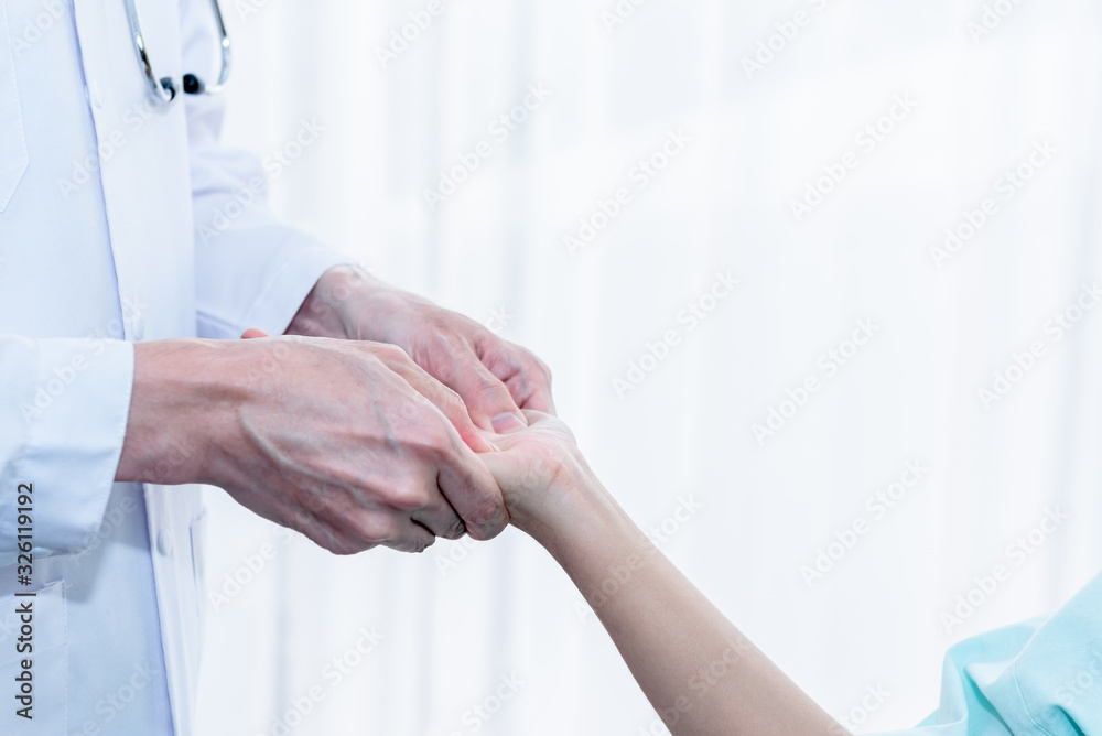 The doctor pressed his finger on the palm of the patient In order to lelive pain And make patients feel relaxed, On white background to people and health care cocnept. The doctor pressed his finger on the palm of the patient In order to lelive pain And make patients feel relaxed, On white background to people and health care cocnept.