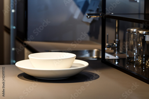 Two bright plates in dark kitchen interior.