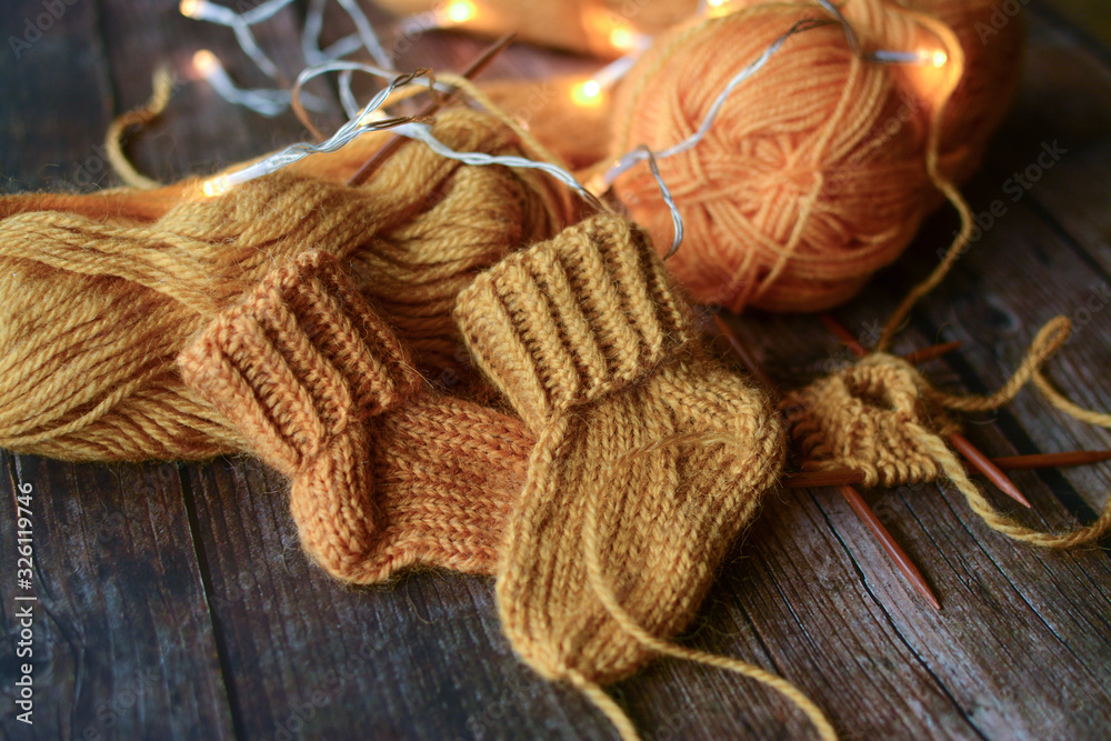 Cute brown baby socks on dark wooden background Cute brown baby socks on dark wooden background