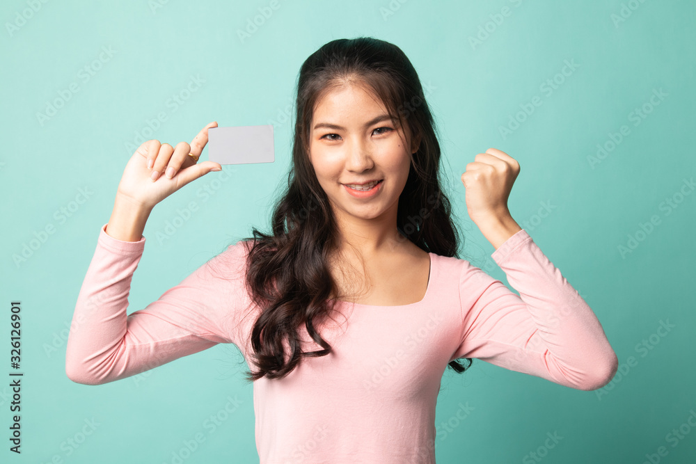 Young Asian woman fist pump with blank card. Young Asian woman fist pump with blank card.