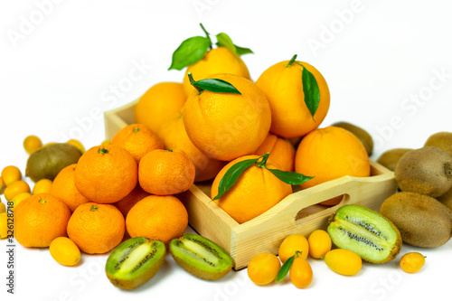 Tropical fruits in bulk  orange  mandarin  kumquat  kiwi. Fresh fruits  food on a white background.