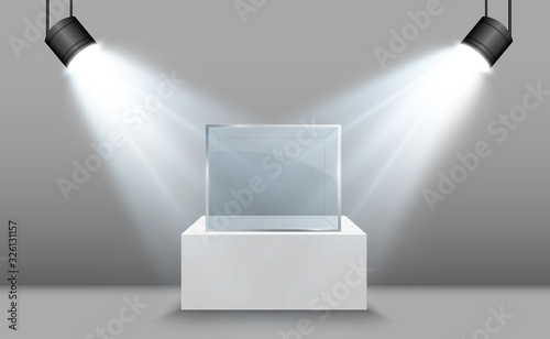 Glass showcase for the exhibition in the form of a cube. Background for sale illuminated by spotlights. Museum glass box isolated advertising or business design boutique. Exhibition hall.