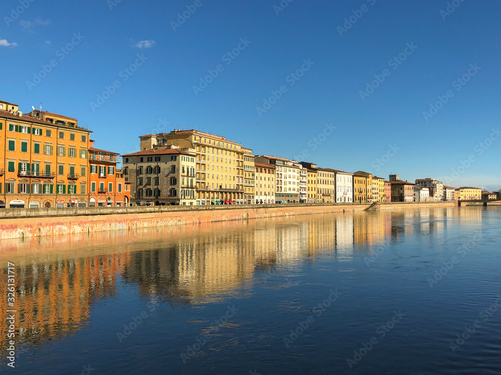 city reflected in river, pisa, italy