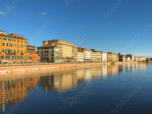 city reflected in river, pisa, italy