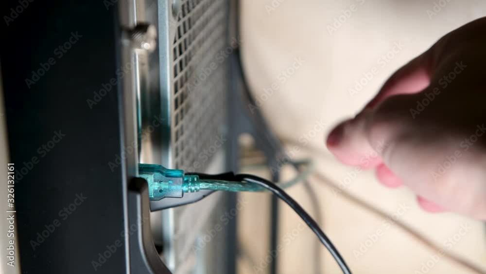 Disconnecting Computer Disconnecting devices from the desktop system unit. A hand takes out ...