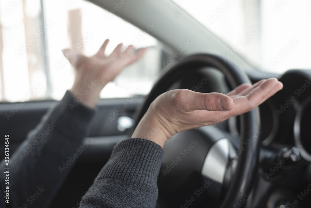Driver is shrugging by his shoulders close up. Driver is shrugging by his shoulders close up.