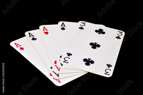 The combination of playing cards in poker on black background - Four of a Kind 