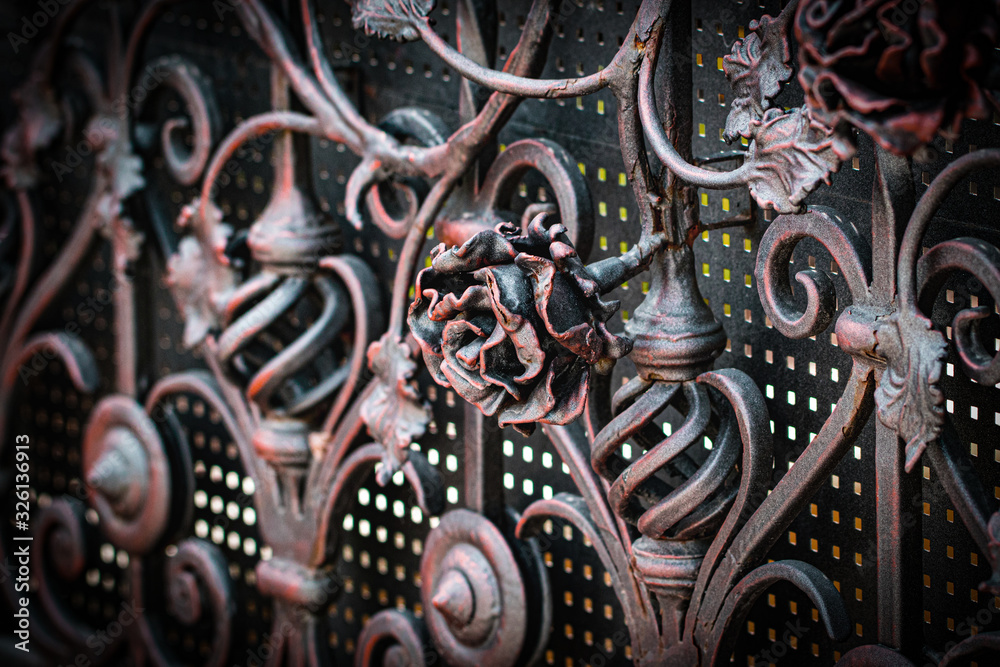 Details, structure and ornaments of forged iron gate. Floral decorative ornament, made from metal. Vintage metallic pattern. Decorative elements as a background