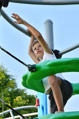 Child on a Playground. Sports and the boy in the summer. Sports holidays