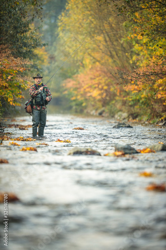 Fotografía Fly fisherman fly fishing on a splendid mountain river