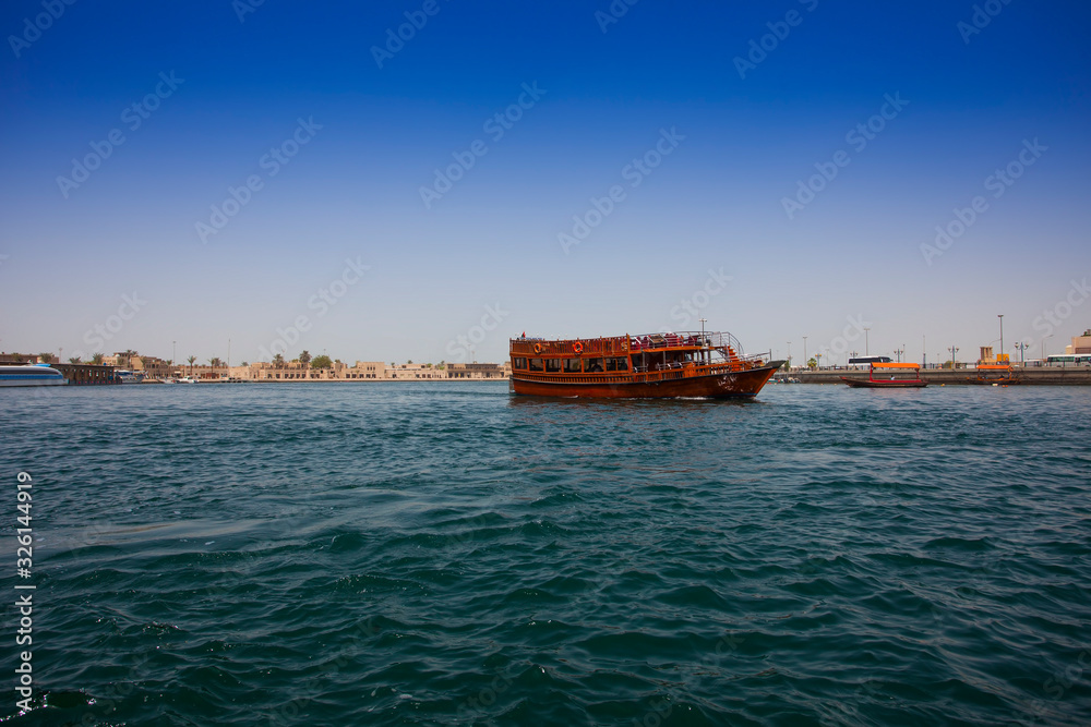 touristic and traditional boat in the old city of Dubai, Deira district. United Arab Emirates