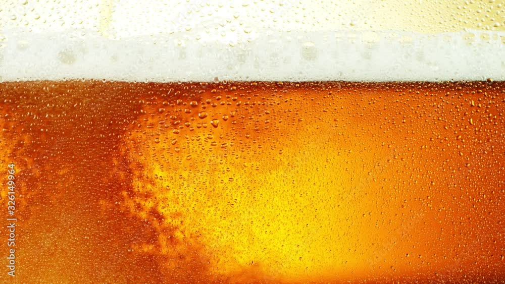 Super slow motion of macro shot of beer drink, close-up. Filmed on high speed cinema camera, 1000 fps. Super slow motion of macro shot of beer drink, close-up. Filmed on high speed cinema camera, 1000 fps.