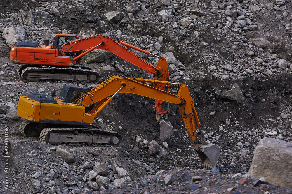 Two excavators digging ground together Two excavators digging ground together