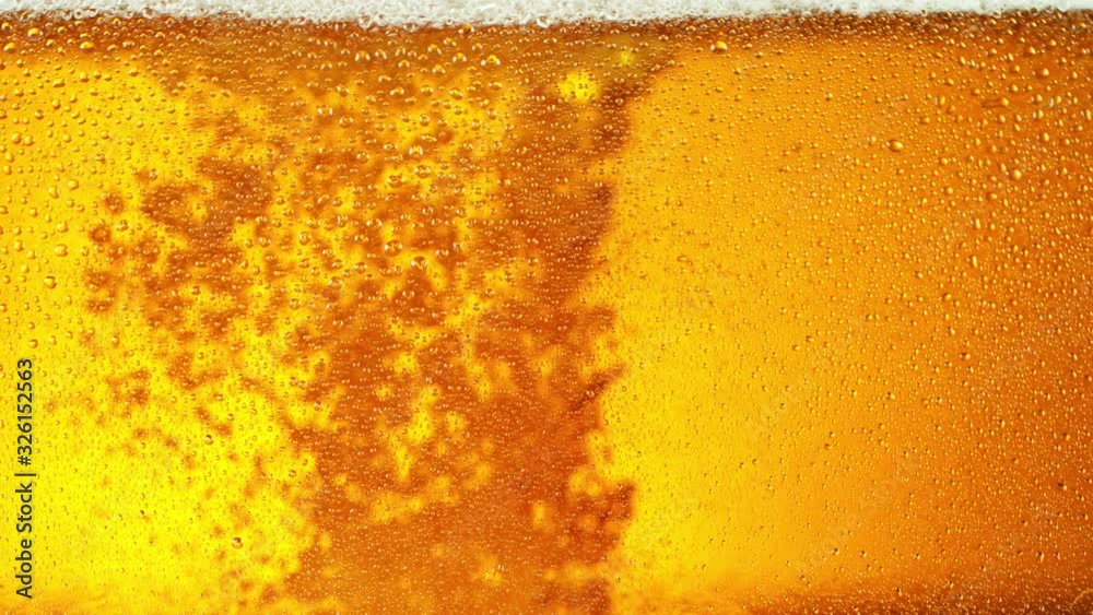 Super slow motion of macro shot of beer drink, close-up. Filmed on high speed cinema camera, 1000 fps. Super slow motion of macro shot of beer drink, close-up. Filmed on high speed cinema camera, 1000 fps.