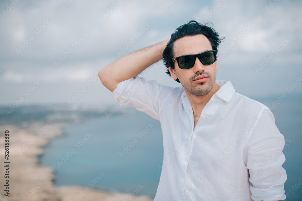 A man on the rocks overlooking the sea A man on the rocks overlooking the sea