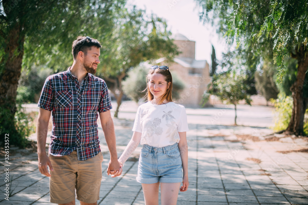 Lovers walk on a shady alley Lovers walk on a shady alley