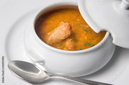 Chicken soup in white bowl on white background.