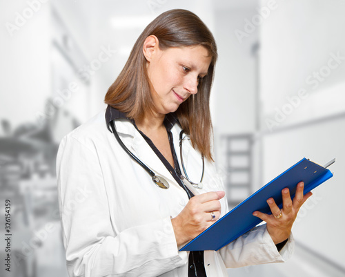 Female doctor looking at medical records in the hospital