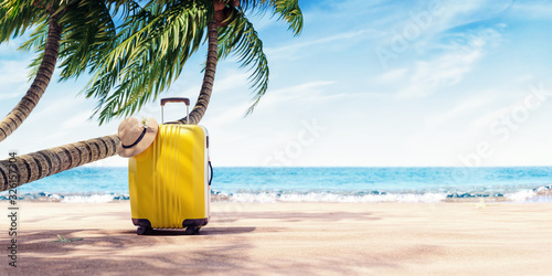 Fototapeta Naklejka Na Ścianę i Meble -  Yellow suitcase under palm tree on sunny beach, travel background 3D Rendering