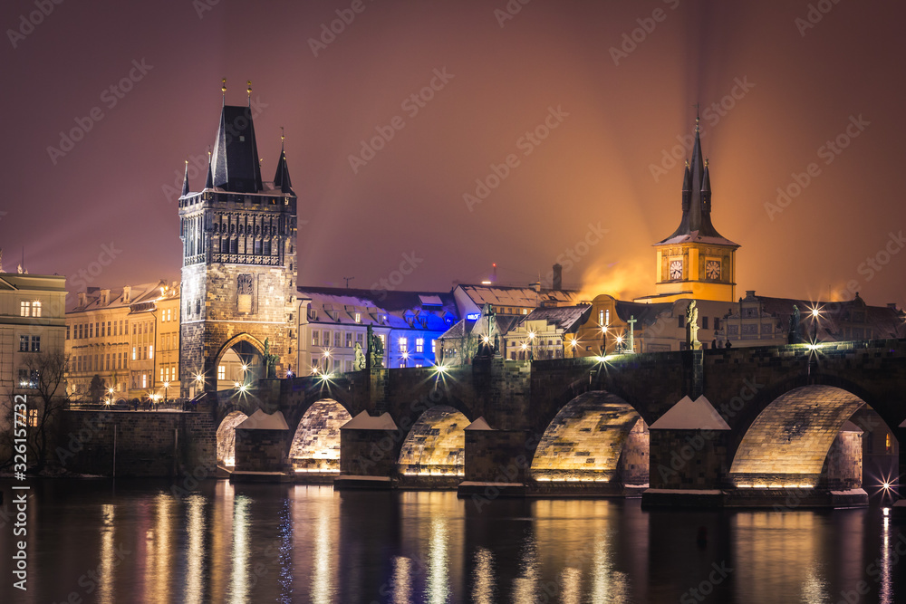 Prague at night, Charles Bridge and its tower from across the river.