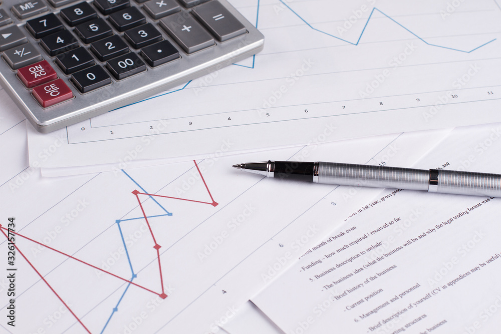 Documents with charts and calculator. Market analysis. Documents with charts and calculator. Market analysis.
