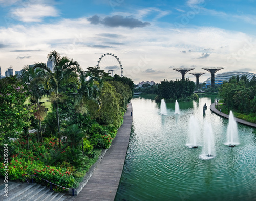 Singapore skyline, Gardens by the Bay after rain, Supertrees on horizon, Singapore. Fountains next to the ticket office, panoramic view