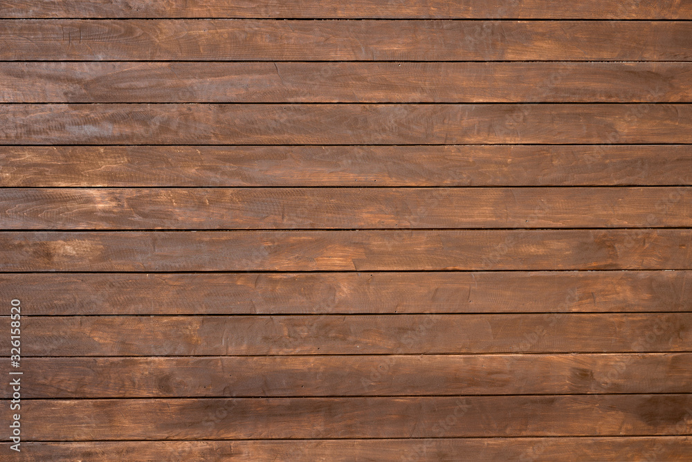 Fototapeta premium Wall of wooden boards covered with stain.