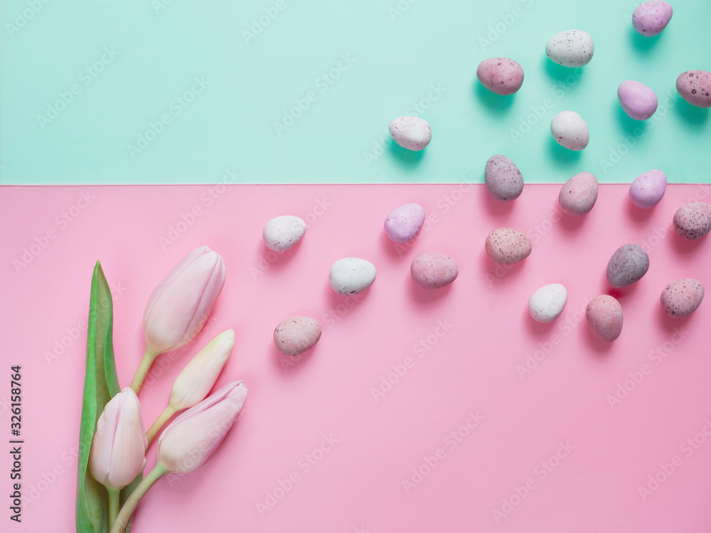 Pink pastel Easter with delicate tulips, sweet meringues and sugar-coated chocolate eggs.