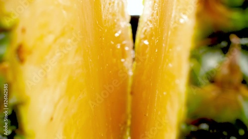 4k abstract video of camera moving between two cut halves of fresh pineapple. Perfect abstract shot for organic food and healthy nutrition. Tropical fruits photo