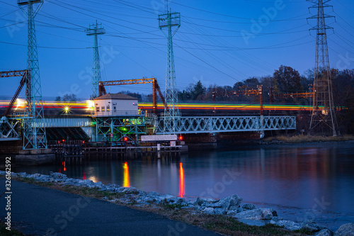 train lights long exposure across bridge over water