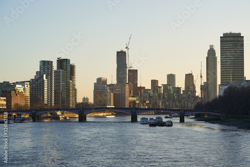 Wallpaper Mural Cityscape or panoramatic Picture of London, capitol of Great Britain, taken in sunny sunset during the golden hour shown bridge over the river Thames and modern architecture with skyscrapers. Torontodigital.ca