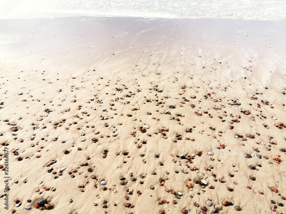 Close-up of wet sand with pebbles. Baltic Sea coast. Close-up of wet sand with pebbles. Baltic Sea coast.