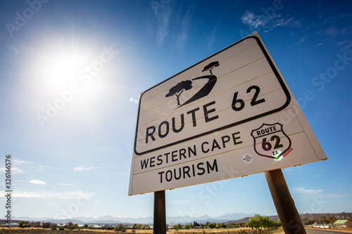 Wide angle shot of road sign Route 62, South Africa, with sun flare