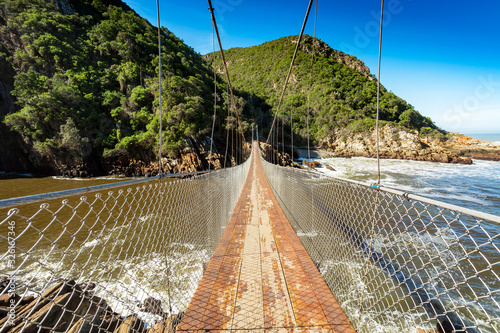 Suspension bridge in center of picture crossing river, Tsitsikamma national park South Africa