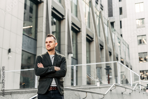 Wallpaper Mural A man stands with his arms crossed in the downtown Torontodigital.ca