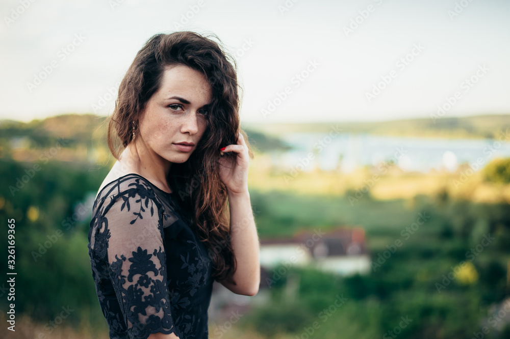 Girl in a black dress and magnificent wavy hair on the nature. Girl in a black dress and magnificent wavy hair on the nature.