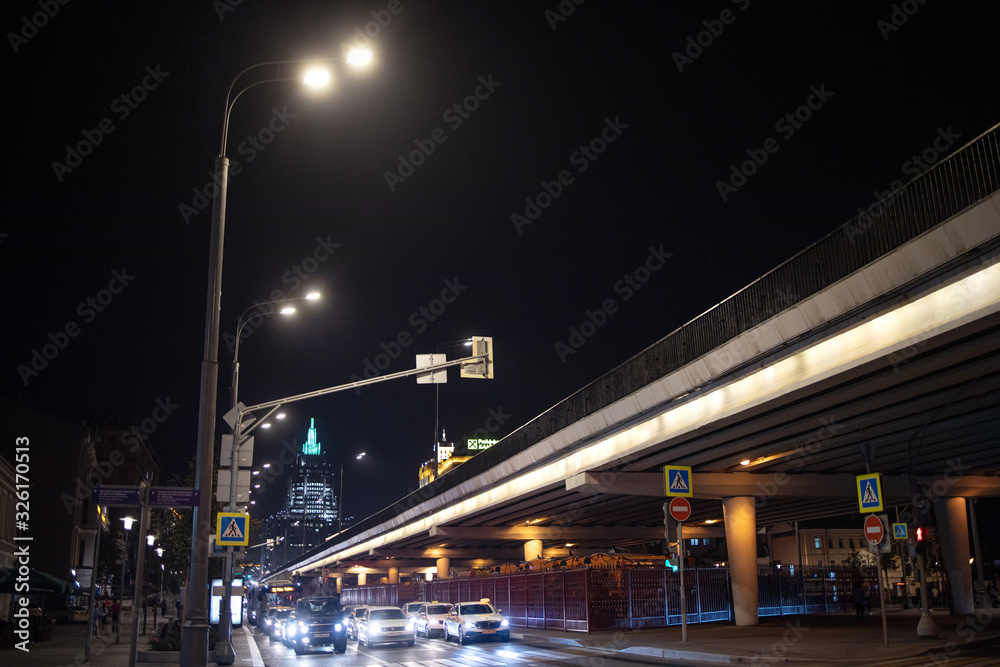Russia, Moscow - September 8, 2019: Night crossroad. Cars on the road. Big city night life. City street. Beautiful view of downtown. Blurred concept...
