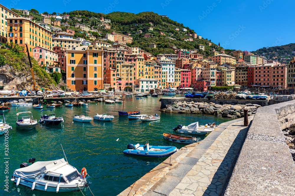 Boats along pier in small harbour of Camogli, Italy.