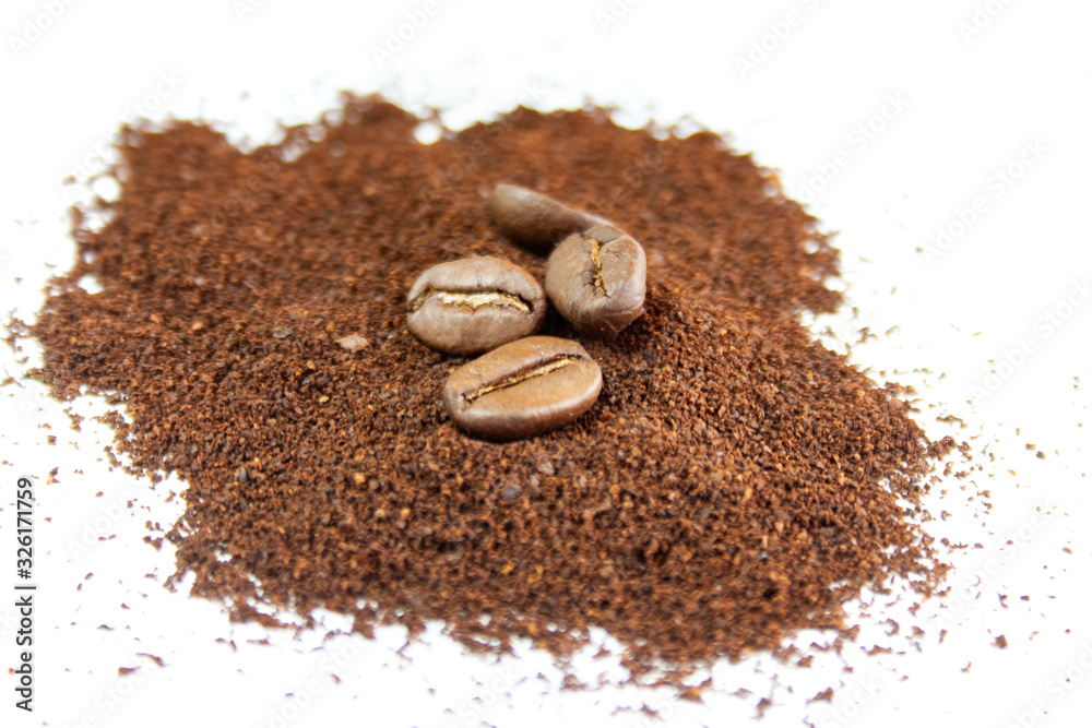 Coffee beans and ground coffee on a white background