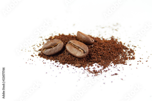 Coffee beans and ground coffee on a white background © Monika