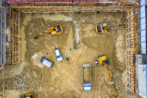 Obraz na płótnie Heavy construction equipment working at the construction site. Aerial view from drone w salonie