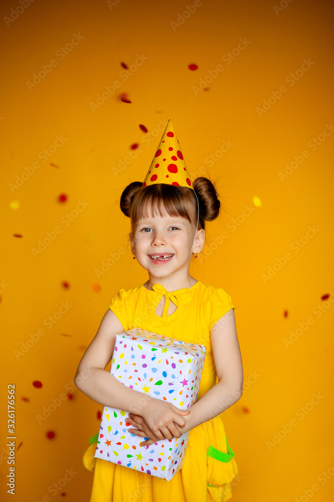happy birthday happy girl with confetti on color yellow background