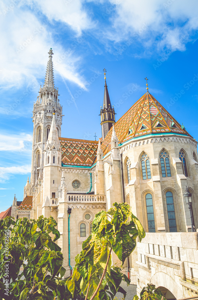 Vertical photo of the Matthias Church, also known as the Church of the Assumption of the Buda Castle, in Budapest, Hungary. Amazing Gothic Cathedral in the Hungarian capital city. Tourist landmark