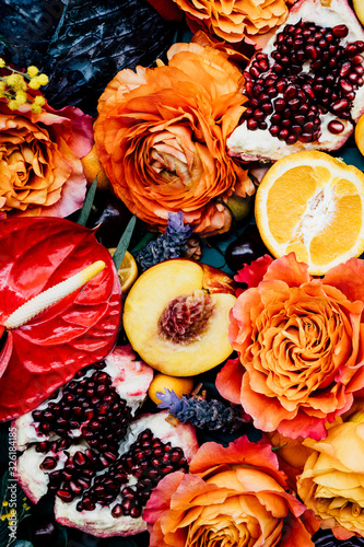 Lush still life arrangement of variety of colorful fruits and flowers photo