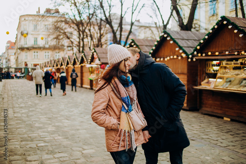 Loving couple walking through the street of the ancient city © Yuliia