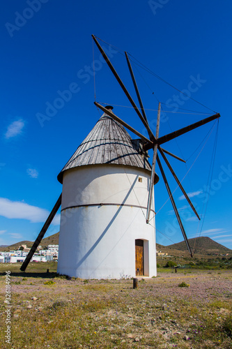 windmill traditional in Spain, Pozo de los Frailes, province of Almeria, windmill under blue sky, traditional white windmill